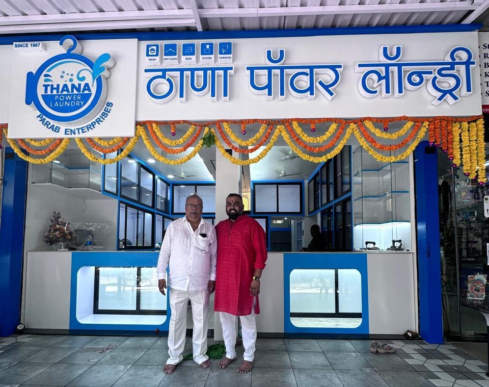 Thana Power Laundry family owners standing outside their store